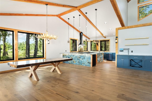 600 Ringneck Dr, Kalispell, MT 59901 - unfurnished dining area featuring high vaulted ceiling, beamed ceiling, wood finished floors, and a chandelier