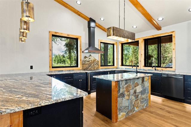 600 Ringneck Dr, Kalispell, MT 59901 - kitchen with stainless steel dishwasher, wall chimney range hood, dark cabinets, plenty of natural light, and recessed lighting