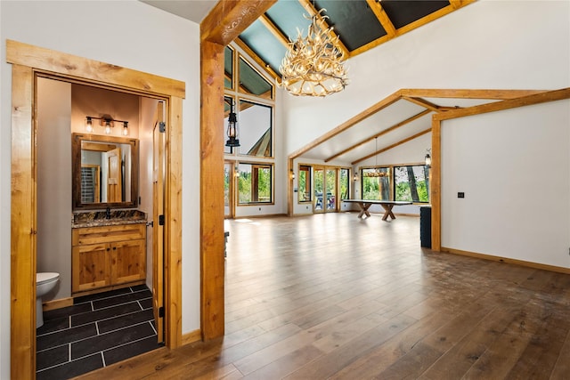 600 Ringneck Dr, Kalispell, MT 59901 - corridor with a chandelier, beam ceiling, dark wood finished floors, and high vaulted ceiling