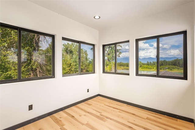 600 Ringneck Dr, Kalispell, MT 59901 - unfurnished room featuring wood finished floors, recessed lighting, and a mountain view