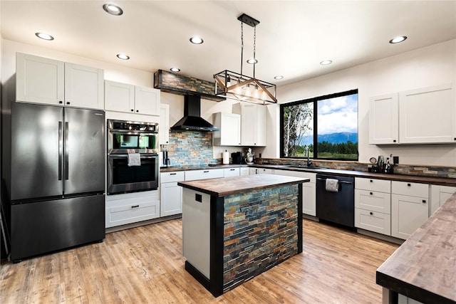 600 Ringneck Dr, Kalispell, MT 59901 - kitchen with black appliances, butcher block countertops, wall chimney range hood, backsplash, and light wood-style flooring