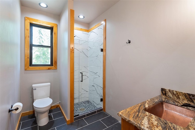 600 Ringneck Dr, Kalispell, MT 59901 - bathroom featuring vanity, a marble finish shower, tile patterned floors, and recessed lighting