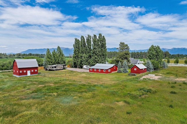 1380 Lower Valley Rd, Kalispell, MT 59901 - view of yard featuring a barn, a mountain view, an outdoor structure, and a view of countryside