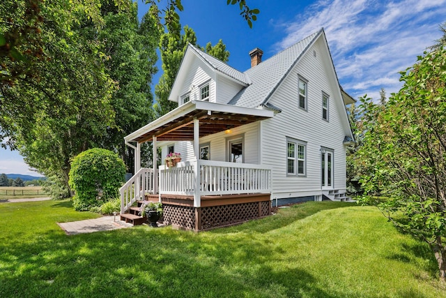 1380 Lower Valley Rd, Kalispell, MT 59901 - view of front of home with a front lawn, a chimney, and a wooden deck