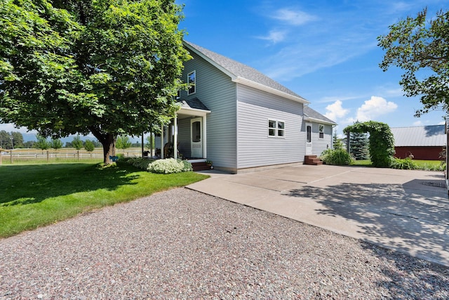 1380 Lower Valley Rd, Kalispell, MT 59901 - view of side of home with concrete driveway, a porch, and a shingled roof