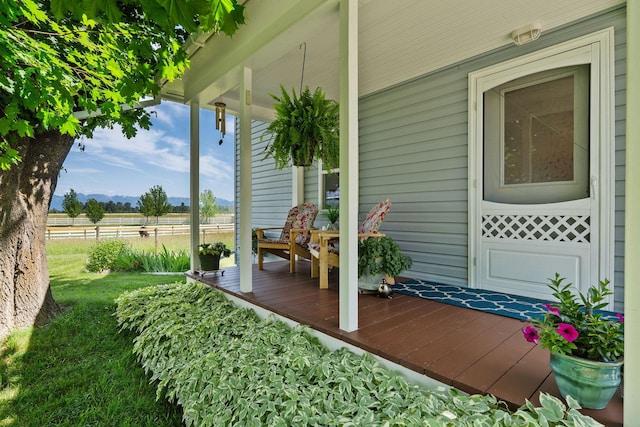 1380 Lower Valley Rd, Kalispell, MT 59901 - view of exterior entry featuring a porch, a view of countryside, and a mountain view