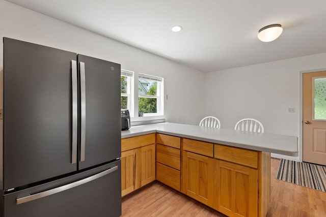 1380 Lower Valley Rd, Kalispell, MT 59901 - kitchen featuring freestanding refrigerator, a peninsula, light wood-style flooring, light countertops, and recessed lighting