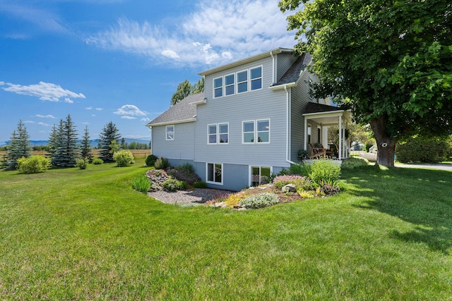 1380 Lower Valley Rd, Kalispell, MT 59901 - rear view of house with a lawn and a shingled roof