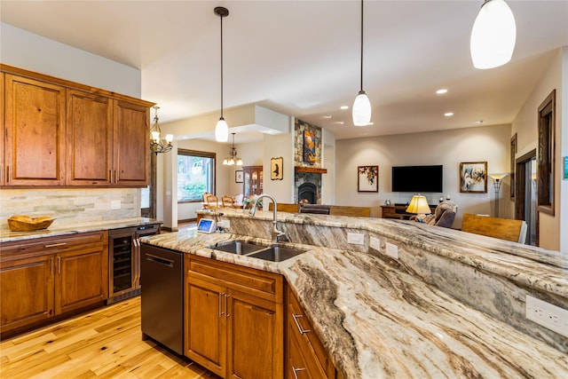 33731 Westview Dr, Bigfork, MT 59911 - kitchen with beverage cooler, dishwashing machine, a chandelier, brown cabinetry, and light wood-type flooring