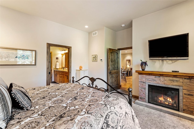33731 Westview Dr, Bigfork, MT 59911 - carpeted bedroom with recessed lighting, ensuite bathroom, and a stone fireplace