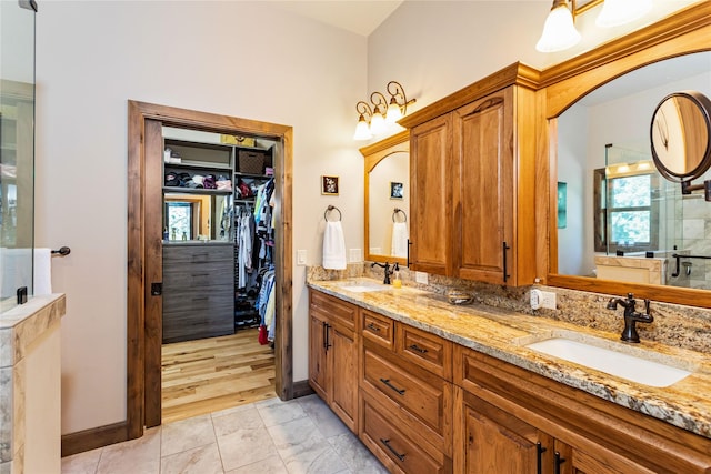 33731 Westview Dr, Bigfork, MT 59911 - bathroom with double vanity, a spacious closet, and an enclosed shower