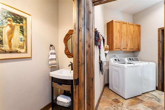 33731 Westview Dr, Bigfork, MT 59911 - laundry room with washing machine and clothes dryer, cabinet space, and light stone finish floors