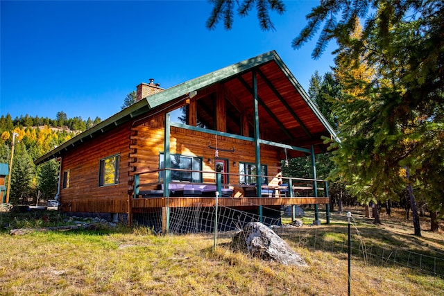630 Tally Lake Rd, Whitefish, MT 59937 - back of property featuring a chimney and log siding