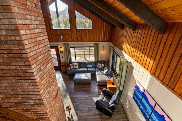 630 Tally Lake Rd, Whitefish, MT 59937 - living area with hardwood / wood-style flooring, high vaulted ceiling, wood walls, brick wall, and a wood ceiling with exposed beams