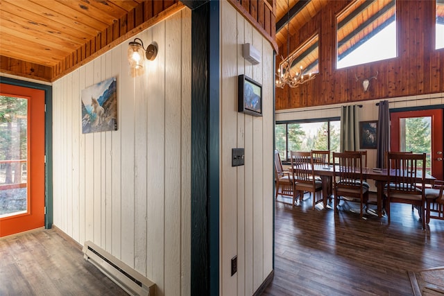 630 Tally Lake Rd, Whitefish, MT 59937 - hall featuring a baseboard heating unit, wooden ceiling, wood walls, healthy amount of natural light, and a chandelier