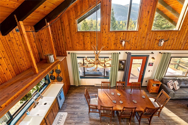 630 Tally Lake Rd, Whitefish, MT 59937 - dining area with high vaulted ceiling, a mountain view, a wood ceiling with exposed beams, dark wood-type flooring, and a chandelier