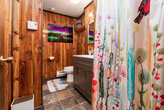 630 Tally Lake Rd, Whitefish, MT 59937 - full bath featuring a baseboard heating unit, wooden walls, vanity, stone finish flooring, and a shower with curtain