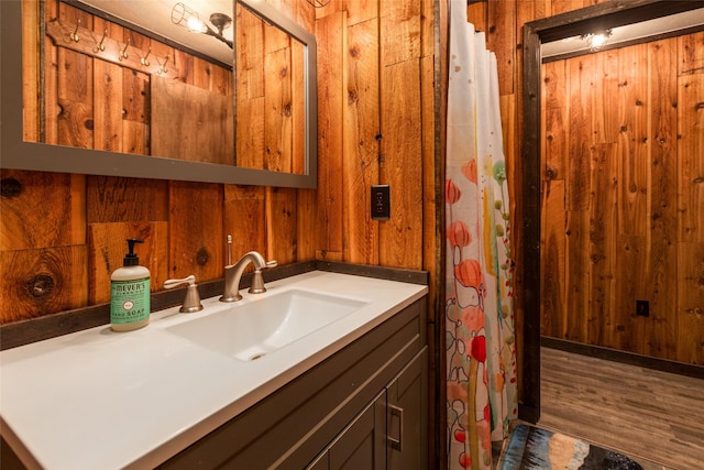 630 Tally Lake Rd, Whitefish, MT 59937 - full bath featuring vanity, wood walls, and wood finished floors