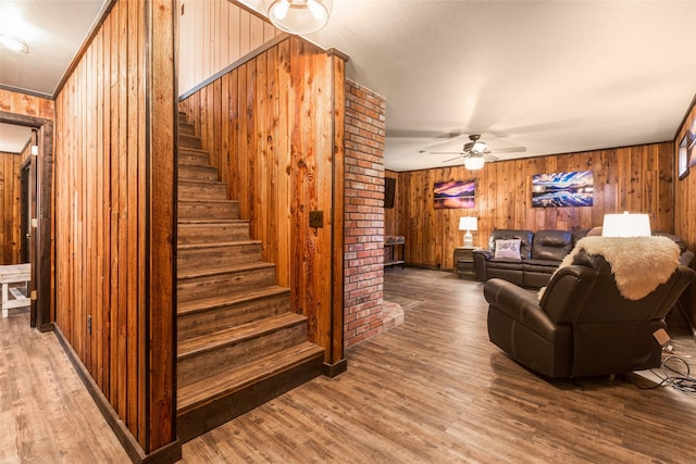 630 Tally Lake Rd, Whitefish, MT 59937 - living room with stairs, wood finished floors, wooden walls, and a ceiling fan