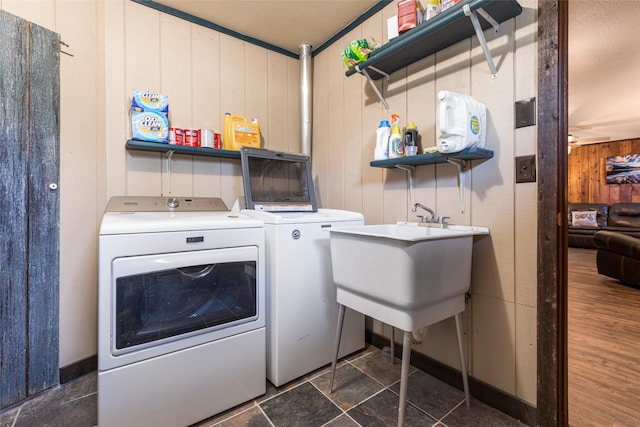 630 Tally Lake Rd, Whitefish, MT 59937 - washroom featuring washing machine and dryer and wooden walls