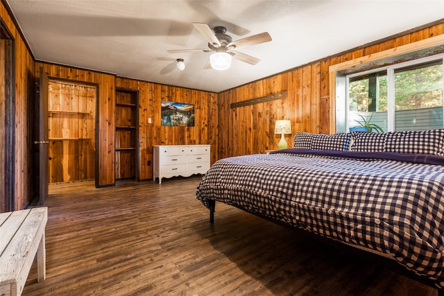 630 Tally Lake Rd, Whitefish, MT 59937 - bedroom featuring wooden walls, wood finished floors, crown molding, and a ceiling fan