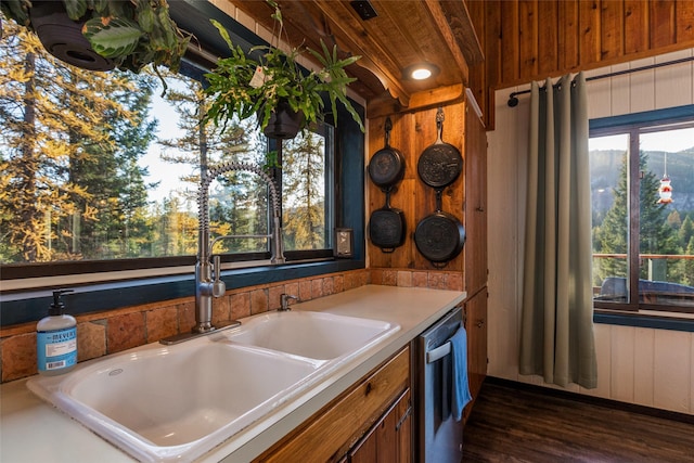 630 Tally Lake Rd, Whitefish, MT 59937 - kitchen with dishwasher, dark wood finished floors, brown cabinetry, and light countertops