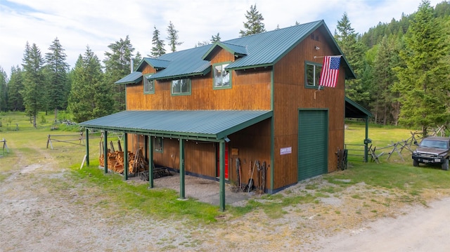 630 Tally Lake Rd, Whitefish, MT 59937 - exterior space featuring a metal roof, a garage, driveway, and a carport