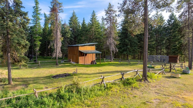 630 Tally Lake Rd, Whitefish, MT 59937 - view of yard with an outbuilding and a forest view