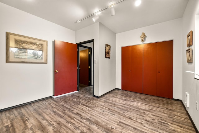 630 Tally Lake Rd, Whitefish, MT 59937 - unfurnished bedroom with track lighting, wood finished floors, and a closet
