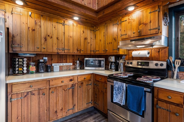 630 Tally Lake Rd, Whitefish, MT 59937 - kitchen featuring stainless steel appliances, under cabinet range hood, light countertops, brown cabinetry, and dark wood finished floors