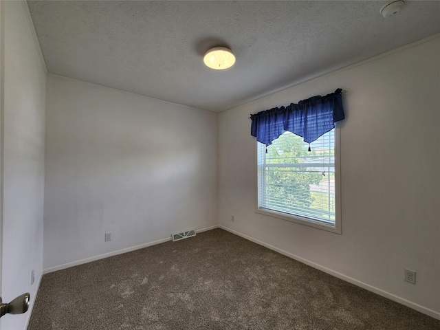 1208 8th Ave NW, Great Falls, MT 59404 - spare room with dark colored carpet, a textured ceiling, and a smoke detector