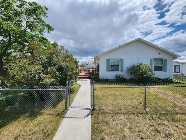 1208 8th Ave NW, Great Falls, MT 59404 - view of side of property with a fenced front yard, a gate, and a deck