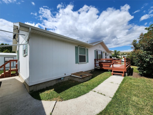 1208 8th Ave NW, Great Falls, MT 59404 - view of side of home with a deck, a yard, and a storage shed