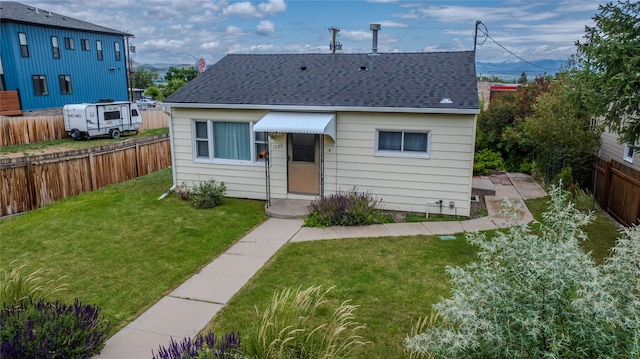 1220 Cannon St, Helena, MT 59601 - view of front of property featuring a shingled roof and a fenced backyard