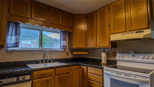 1220 Cannon St, Helena, MT 59601 - kitchen featuring white range with electric cooktop, under cabinet range hood, dishwashing machine, and dark countertops