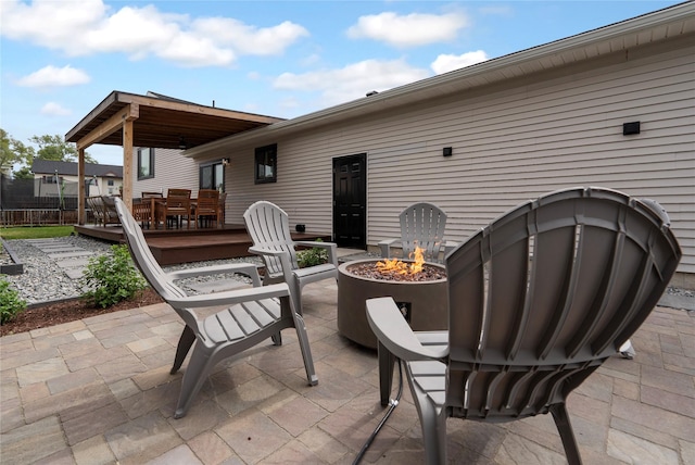 301 Buttercup Loop, Kalispell, MT 59901 - view of patio with an outdoor fire pit, a wooden deck, and outdoor dining area
