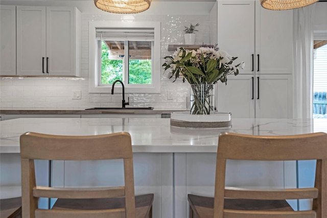 301 Buttercup Loop, Kalispell, MT 59901 - kitchen with tasteful backsplash and light stone counters