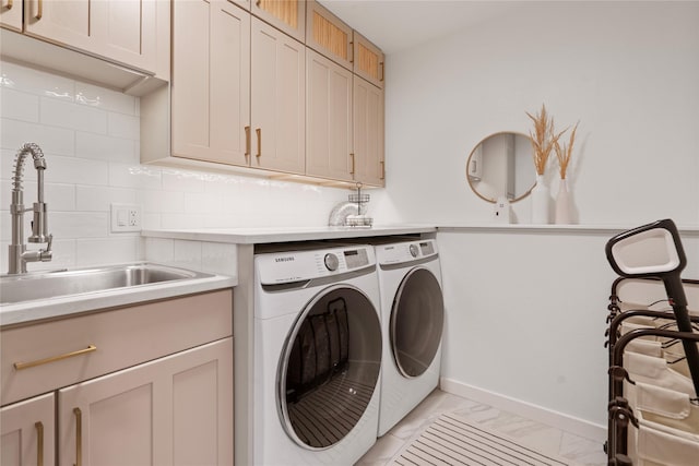 301 Buttercup Loop, Kalispell, MT 59901 - laundry area featuring independent washer and dryer, cabinet space, and light marble finish flooring