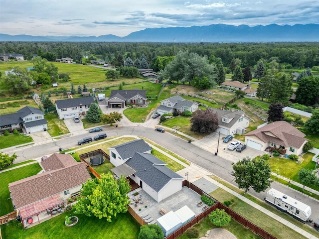 301 Buttercup Loop, Kalispell, MT 59901 - aerial view of residential area featuring a mountain backdrop and a heavily wooded area