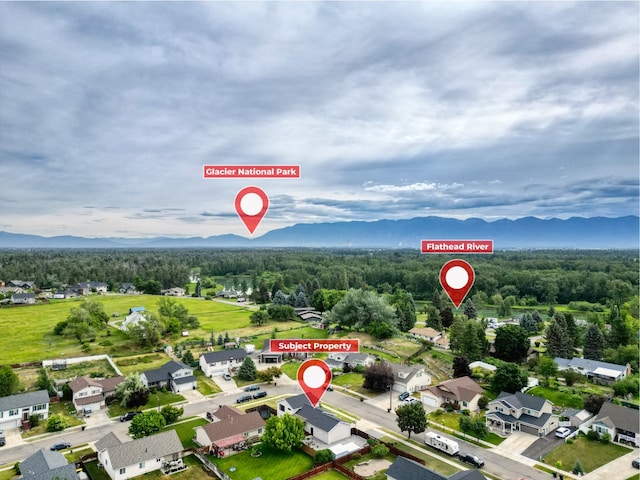 301 Buttercup Loop, Kalispell, MT 59901 - aerial overview of property's location featuring a mountainous background and nearby suburban area