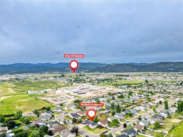 301 Buttercup Loop, Kalispell, MT 59901 - aerial view of property and surrounding area with a mountain backdrop and nearby suburban area