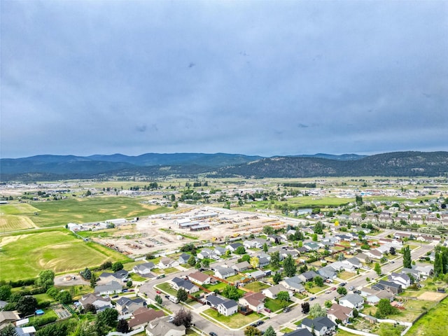 301 Buttercup Loop, Kalispell, MT 59901 - aerial overview of property's location featuring a mountain backdrop and nearby suburban area