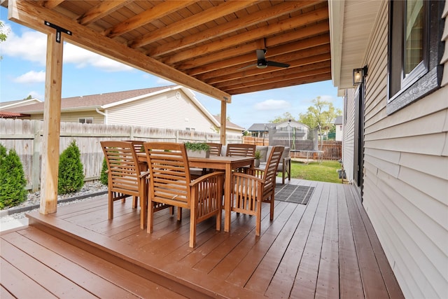 301 Buttercup Loop, Kalispell, MT 59901 - wooden deck with a trampoline, a fenced backyard, and outdoor dining area