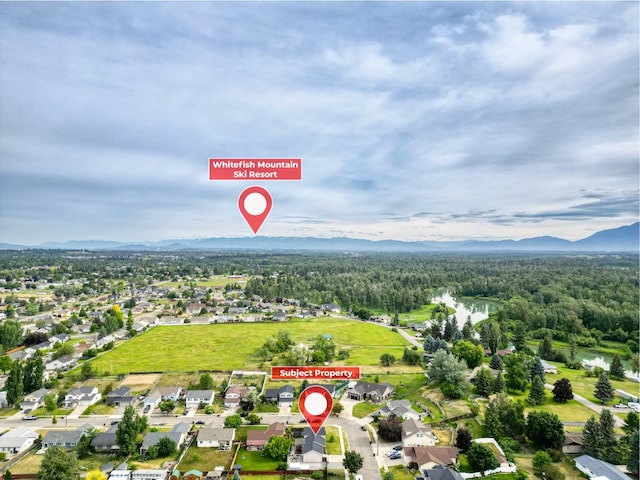 301 Buttercup Loop, Kalispell, MT 59901 - aerial view of property and surrounding area with mountains and nearby suburban area