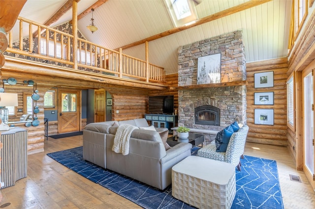 2755 US Highway 93 W, Whitefish, MT 59937 - living room with high vaulted ceiling, rustic walls, wood-type flooring, beamed ceiling, and a fireplace