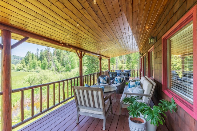 2755 US Highway 93 W, Whitefish, MT 59937 - wooden terrace with an outdoor living space and a wooded view