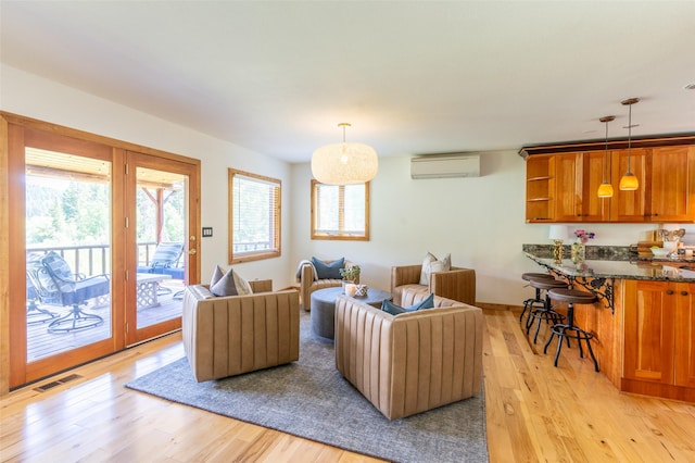 2755 US Highway 93 W, Whitefish, MT 59937 - living room featuring a wall unit AC, healthy amount of natural light, and light wood-style floors