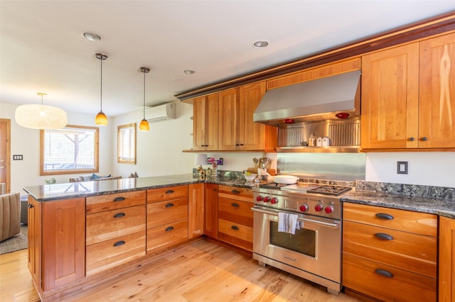 2755 US Highway 93 W, Whitefish, MT 59937 - kitchen with premium stove, wall chimney range hood, a peninsula, light wood finished floors, and recessed lighting