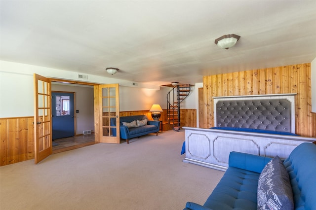 2755 US Highway 93 W, Whitefish, MT 59937 - carpeted living room featuring wooden walls, french doors, wainscoting, and stairs