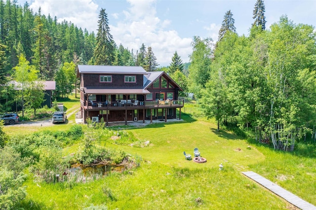 2755 US Highway 93 W, Whitefish, MT 59937 - back of property featuring a wooden deck and a yard